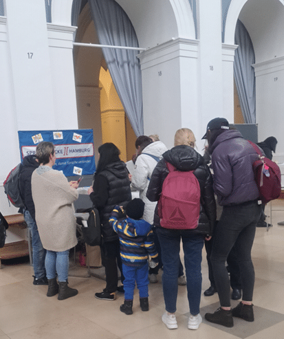 Menschen vor dem Sprachbrücke-Hamburg-Stand beim „Marktplatz der Begegnungen“ in der Handelskammer Hamburg